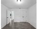 Neutral bedroom featuring wood-look tile floors, white walls, closet, and modern doors at 2372 Bonanza Ln, North Port, FL 34286