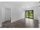Dining room with wood-look tile floors, chandelier, sliding glass door to yard and closet at 2372 Bonanza Ln, North Port, FL 34286