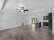 Open-concept living room featuring wood-look tile floors and modern lighting fixtures at 2372 Bonanza Ln, North Port, FL 34286