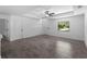 Bright living room features a ceiling fan, fresh neutral paint and attractive wood-look tile flooring at 2372 Bonanza Ln, North Port, FL 34286