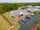Beautiful aerial view of the property showing landscaping, parking, and surrounding wooded areas at 25068 Harborview Rd # 1B, Punta Gorda, FL 33980