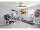 Bedroom with tile floors, ceiling fan, mirrored closet doors and exercise equipment at 25068 Harborview Rd # 1B, Punta Gorda, FL 33980