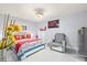 Cozy bedroom with tile flooring, a ceiling fan, and a comfortable seating area at 25068 Harborview Rd # 1B, Punta Gorda, FL 33980