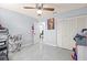 Bedroom features tile floors, closet, ceiling fan, and neutral paint at 25068 Harborview Rd # 1B, Punta Gorda, FL 33980