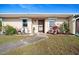 Charming front entrance featuring a well-manicured lawn and inviting doorway with decorative plants at 25068 Harborview Rd # 1B, Punta Gorda, FL 33980