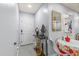 Inviting hallway with tile flooring, a mirrored wall accent, and view of the entryway door at 25068 Harborview Rd # 1B, Punta Gorda, FL 33980