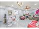 Bright and airy living room featuring a fireplace, modern decor, and a view to the kitchen at 25068 Harborview Rd # 1B, Punta Gorda, FL 33980