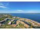 Stunning aerial view of waterfront condos and homes on beautiful blue bay with bridge in distance at 25188 Marion Ave # F307, Punta Gorda, FL 33950