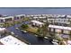 Aerial view of waterfront community featuring boats docked in the canal and views of multi-story residences at 25188 Marion Ave # F307, Punta Gorda, FL 33950