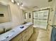 Bathroom featuring double sinks, great lighting and a step-in shower at 25188 Marion Ave # F307, Punta Gorda, FL 33950