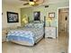 Inviting bedroom with flamingo-themed bedding, two nightstands, and a private en-suite bathroom at 25188 Marion Ave # F307, Punta Gorda, FL 33950