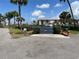 Community boat ramp provides access to the water, framed by lush palm trees and landscaping at 25188 Marion Ave # F307, Punta Gorda, FL 33950