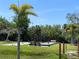 Bocce ball court with benches surrounded by tropical landscape in a well-maintained community at 25188 Marion Ave # F307, Punta Gorda, FL 33950