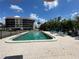 Community pool surrounded by lush greenery and lounge chairs, perfect for relaxation at 25188 Marion Ave # F307, Punta Gorda, FL 33950