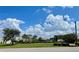 Beautiful community with green spaces, palm trees, and blue skies, perfect for outdoor living at 25188 Marion Ave # F307, Punta Gorda, FL 33950