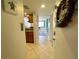 Condo entryway with tile flooring and a glimpse of the kitchen and living area at 25188 Marion Ave # F307, Punta Gorda, FL 33950