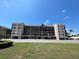 Exterior of condo building featuring covered parking, neutral paint, and a well-maintained landscape at 25188 Marion Ave # F307, Punta Gorda, FL 33950