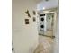 Hallway featuring a mirrored wall, stackable washer/dryer and access to other living areas at 25188 Marion Ave # F307, Punta Gorda, FL 33950