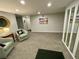 Condo hallway with neutral carpet, accent furniture, and decorative mirrors and artwork at 25188 Marion Ave # F307, Punta Gorda, FL 33950