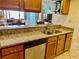 Granite countertops highlight the spacious kitchen, which opens up to the great room at 25188 Marion Ave # F307, Punta Gorda, FL 33950