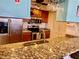 Kitchen with granite countertops, cabinetry, and stainless steel appliances at 25188 Marion Ave # F307, Punta Gorda, FL 33950