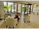 Inviting condo lobby with comfortable seating, tiled floor, and views of the lush exterior at 25188 Marion Ave # F307, Punta Gorda, FL 33950