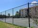 Outdoor tennis courts behind a chain link fence with well maintained landscaping and clear blue sky on a sunny day at 25188 Marion Ave # F307, Punta Gorda, FL 33950