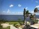 Serene view of bay from balcony with palm trees and tropical vegetation at 25188 Marion Ave # F307, Punta Gorda, FL 33950