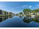 Still, blue water view of waterfront community with docks and boats, with condo buildings set among palm and shade trees at 25188 Marion Ave # F307, Punta Gorda, FL 33950