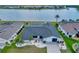 Aerial view of a one-story home with a screened pool and a beautiful lake view from the backyard at 25319 Vantage Ln, Punta Gorda, FL 33983