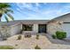 Close-up view of the home's front entrance with rock landscaping and a stone facade at 25319 Vantage Ln, Punta Gorda, FL 33983