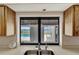 View of a beautiful screened-in pool and lake from the kitchen window at 25319 Vantage Ln, Punta Gorda, FL 33983