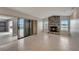 Bright living room with a stone fireplace, tiled flooring and sliding doors to the screened pool area at 25319 Vantage Ln, Punta Gorda, FL 33983