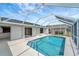 Enclosed swimming pool featuring clear water, tile accents and a patio for lounging and entertaining guests at 25319 Vantage Ln, Punta Gorda, FL 33983
