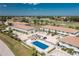 Aerial shot of community pool and condos with view of golf course at 26396 Nadir Rd # 507, Punta Gorda, FL 33983