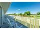 Balcony with chairs overlooking a lush green golf course on a sunny day offering great views at 26396 Nadir Rd # 507, Punta Gorda, FL 33983