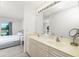 Bathroom featuring a vanity with double sinks, good lighting, and convenient access to the bedroom at 26396 Nadir Rd # 507, Punta Gorda, FL 33983