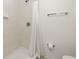 Tiled shower stall featuring chrome fixtures, a shower curtain, and a mounted towel bar at 26396 Nadir Rd # 507, Punta Gorda, FL 33983
