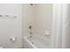 Well-lit bathroom featuring a shower over tub combination and neutral tile at 26396 Nadir Rd # 507, Punta Gorda, FL 33983