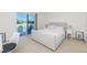 Bright, modern bedroom features a sliding door to a balcony with outdoor seating at 26396 Nadir Rd # 507, Punta Gorda, FL 33983
