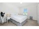 Cozy bedroom with a comfortable bed, golf clubs and ample natural light at 26396 Nadir Rd # 507, Punta Gorda, FL 33983