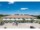 Low-angle view of the condo building, parking and manicured landscaping at 26396 Nadir Rd # 507, Punta Gorda, FL 33983
