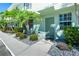 Inviting condo entrance featuring lush landscaping and a well-maintained walkway leading to a painted front door at 26396 Nadir Rd # 507, Punta Gorda, FL 33983