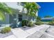 Inviting condo entrance featuring lush landscaping and a well-maintained walkway leading to a painted front door at 26396 Nadir Rd # 507, Punta Gorda, FL 33983