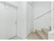 The condo's entryway shows the front door, a closet, and the staircase leading to the second floor at 26396 Nadir Rd # 507, Punta Gorda, FL 33983