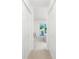 Hallway with closet doors leading to a well-lit living space with exterior views at 26396 Nadir Rd # 507, Punta Gorda, FL 33983