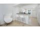 Bright, white kitchen with bar seating and modern appliances is open and inviting at 26396 Nadir Rd # 507, Punta Gorda, FL 33983