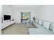 Bright living room with a gray sectional sofa, minimalist decor, and sliding glass doors to a screened-in patio at 26396 Nadir Rd # 507, Punta Gorda, FL 33983