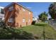 View of the home's backyard with a small lawn, chainlink fence, and mature landscaping on a sunny day at 4158 Tamiami Trl # G1, Port Charlotte, FL 33952