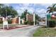 Community entrance of Maria Manor, featuring brick columns, signage, and lush greenery at 4158 Tamiami Trl # G1, Port Charlotte, FL 33952